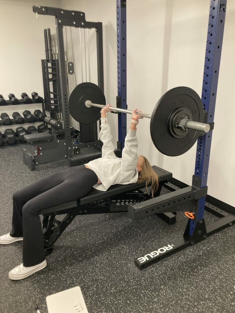 Woman performing bench press exercise